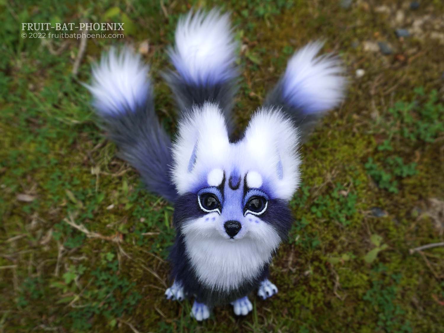 realistic cute fox/kitsune poseable artdoll with three tails sitting and looking up a the viewer