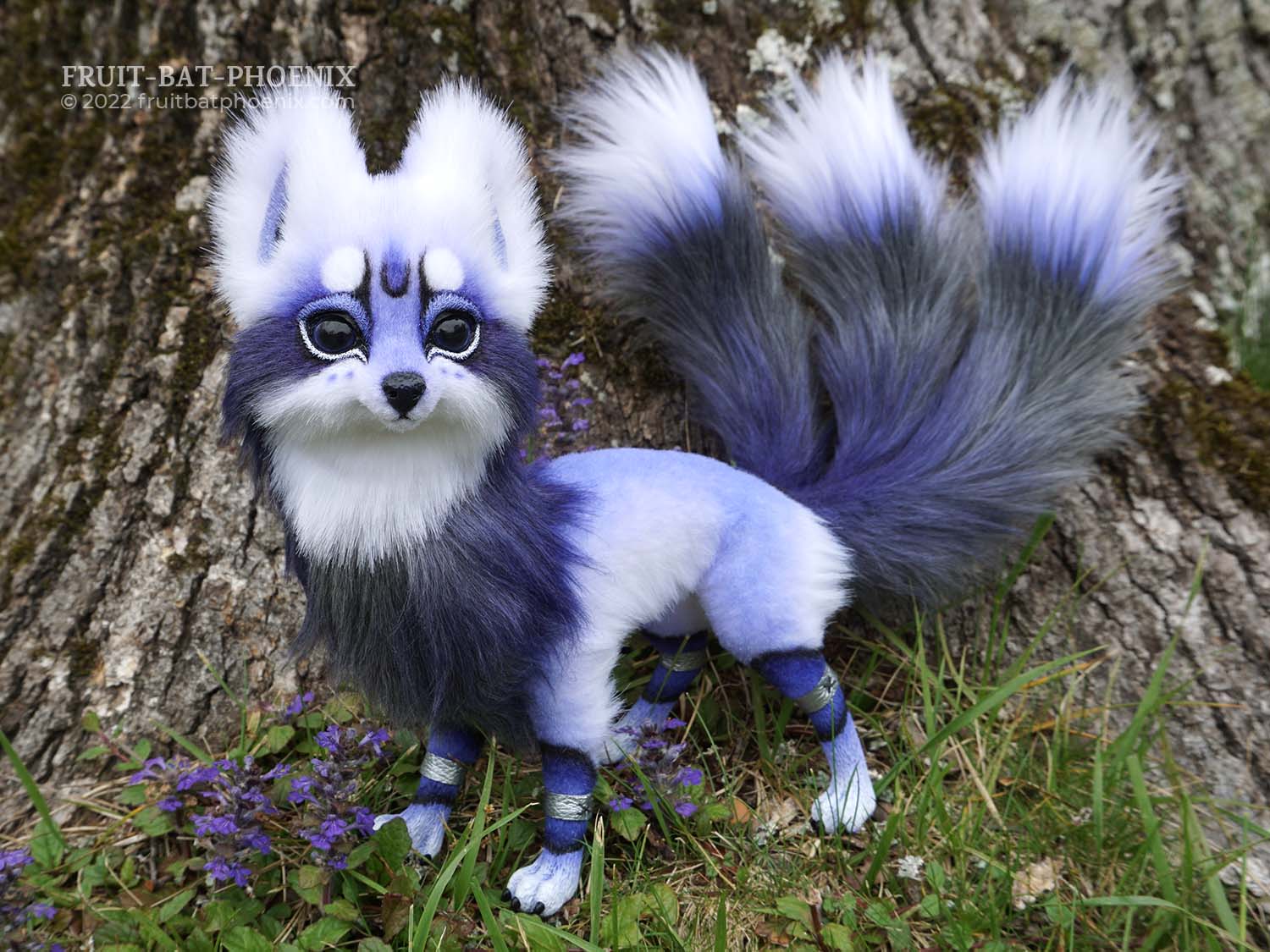 lavender, white, and silver grey stylized fox poseable art doll looks at the viewer