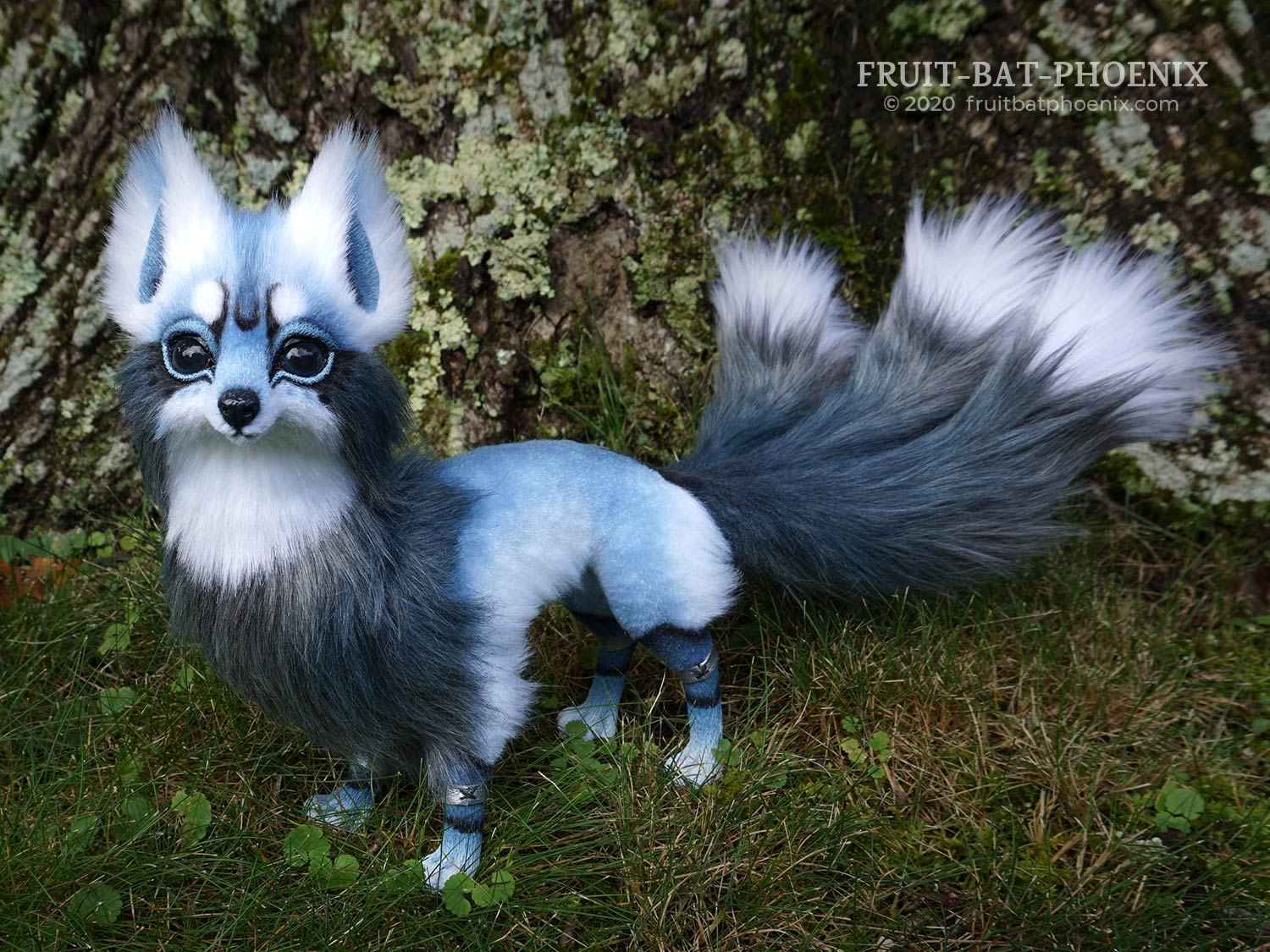 Side view of Rain Kitsune, a posable art doll fox with three tails