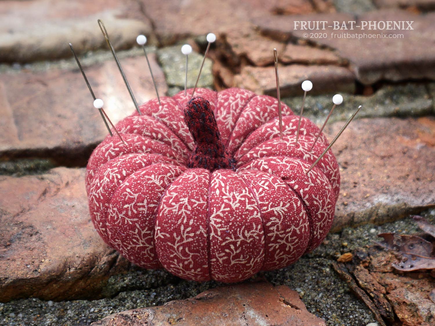 Burgundy red plush pumpkin pincushion with pins