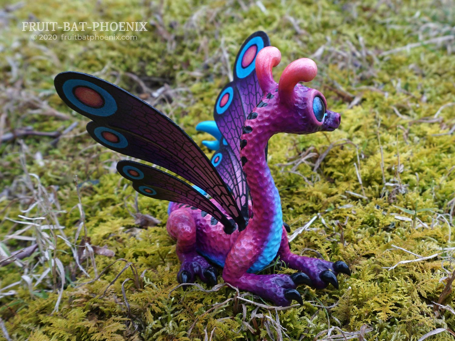 purple and blue dragon sculpture with spotted butterfly wings
