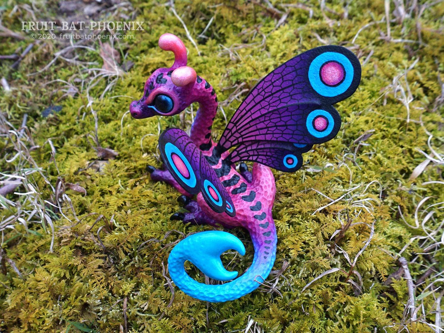 purple dragon sculpture with curled blue tail